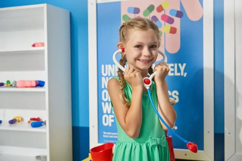 girl playing with toy stethoscope